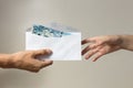 Hand holding giving cash banknote of one thousand Philippinesin envelope peso paying bills, payment procedure or bribe, salary Royalty Free Stock Photo