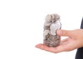 A hand holding a glass bottle full of dollar coins in front of a white background Royalty Free Stock Photo