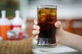 Hand holding glass of cola drink Royalty Free Stock Photo