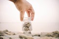 Hand holding glass jar contain with coin at the beach