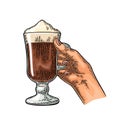 Hand holding glass Latte macchiato coffee with whipped cream. Vintage color vector engraving