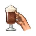 Hand holding glass Latte macchiato coffee with whipped cream. Vintage color vector engraving