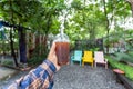 Hand holding glass of Matcha cold foam iced Americano