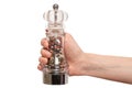 Hand holding glass pepper mill isolated on white background Royalty Free Stock Photo