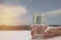 Hand holding a glass of pure water. Hand holding a glass