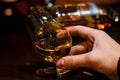 Hand holding a glass of whiskey selective focus Royalty Free Stock Photo