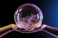 Hand holding a globe. Crystal sphere with hands. Royalty Free Stock Photo