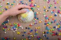 Little model globe amid colorful pebbles Royalty Free Stock Photo