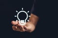 Hand holding glowing light bulb icon. Business success idea Royalty Free Stock Photo