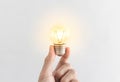 Hand holding glowing light bulb. New ideas, innovation and inspiration concept Royalty Free Stock Photo