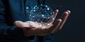 Hand holding a glowing spherical digital network with interconnected nodes and lights Royalty Free Stock Photo