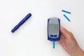 Hand holding glucometer with 7.3 result on display Royalty Free Stock Photo