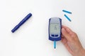 Hand holding glucometer with 6.1 result on display Royalty Free Stock Photo