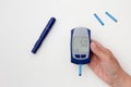 Hand holding glucometer with 5.0 result Royalty Free Stock Photo