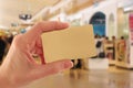 Hand Holding Gold Credit Card in Shopping Mall Royalty Free Stock Photo