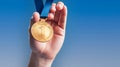 Hand holding gold medal with number 1 on blue background. Generative AI Royalty Free Stock Photo