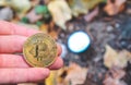 Hand holding Golden and silver bitcoin in autumn in forest , park .Modern exchange value, electronic money virtual pay , Used for