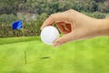 Hand holding golfball