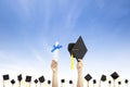 Hand holding graduation hats and diploma Royalty Free Stock Photo