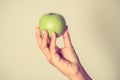 Hand holding green apple with hand with filter effect retro vintage style Royalty Free Stock Photo