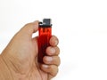 Hand holding green disposable lighter on white background Royalty Free Stock Photo