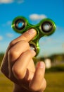 Hand holding green fidget spinner toy Royalty Free Stock Photo