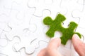 Hand holding a green puzzle piece Royalty Free Stock Photo