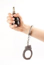 Hand holding a grenade in handcuffs