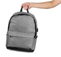 Hand holding grey colour backpack isolated over white background