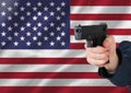 Hand holding gun with American flag Royalty Free Stock Photo