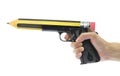 Hand holding gun with pencil point Royalty Free Stock Photo