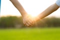 Hand holding hand on sunset sky background Royalty Free Stock Photo