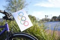 Homemade olympic flag made of paper put on the front of a bicycle