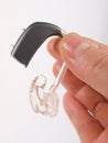 Hand holding hearing aid Royalty Free Stock Photo