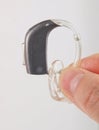 Hand holding hearing aid Royalty Free Stock Photo