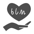 Hand holding heart with BLM text solid icon, Black lives matter concept, BLM heart in hand sign on white background