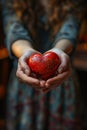 Hand holding a heart-shaped object