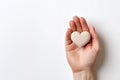 hand holding a heart shaped object white background copy space, ai generative Royalty Free Stock Photo