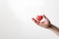 hand holding a heart shaped object white background copy space, ai generative Royalty Free Stock Photo