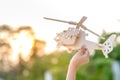 Hand holding helicopter wooden plane toy Royalty Free Stock Photo