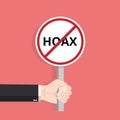 Hand holding hoax word typography sign design illustration. Fight symbol against lies, propaganda and fake news