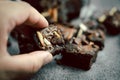 Hand holding homemade dark chocolate brownies topping with almonds slices Royalty Free Stock Photo