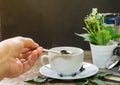 hand holding hot tea cup
