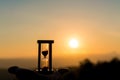 Hand holding Hourglass with sunrise in the morning, Time Concept Royalty Free Stock Photo