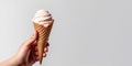 hand holding an ice cream cone on a light background Royalty Free Stock Photo