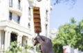 A hand holding ice cream at street.