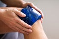 Hand Holding Ice Gel Pack On Knee Royalty Free Stock Photo