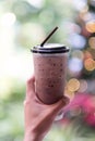 Hand holding iced chocolate or cacao in glass Royalty Free Stock Photo