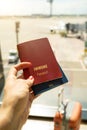 Hand is holding immune passport vaccine document.