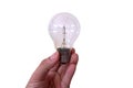 A hand holding a incandescent light bulb isolated on a white background, incandescent lamp, incandescent light globe. Royalty Free Stock Photo